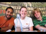 Three lab members smiling together at a restaurant