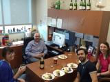 the lab team enjoys cake and champagne for Kathryn's Paper