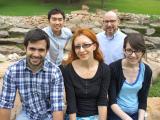 Lab Members sitting outdoors on boulders
