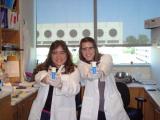 Team members posing as Charlie's Angels pointing equipment that resemble guns