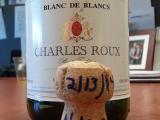 Bottle of champaign and cork on table. Cork is marked "2/13/14 N.KC."