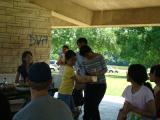 Team members dancing in pavilion at park