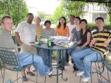 Team members sitting around a table at pool party