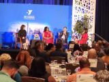panel presenters in front of a seated audience