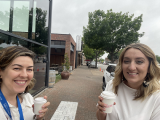two women holding coffees