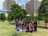 Lab team posing as a group outside university buildings.