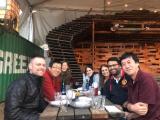Seven lab team members seated at a picnic table.