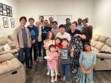 Large group poses for the camera in a living room