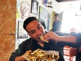 man eating a plate of tacos