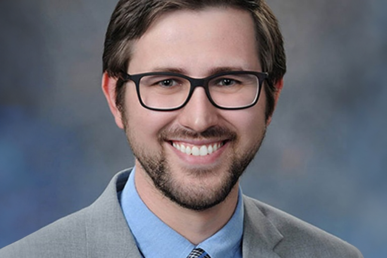 a man with beard and mustache wearing glasses and suit and tie