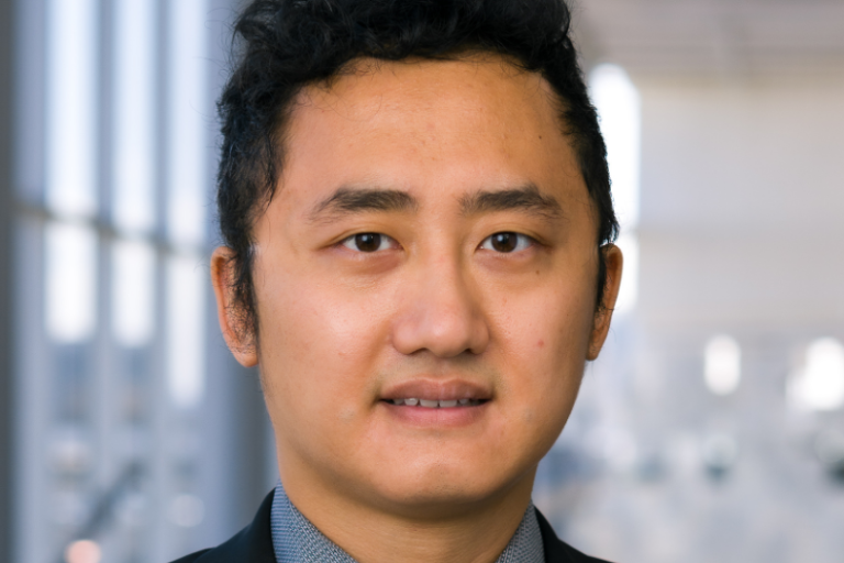 Zijian Deng in black suit with tie