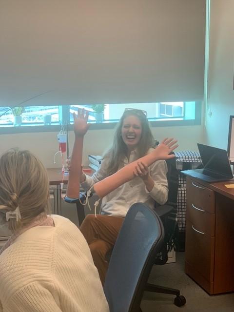 lab personnel playing with fake arms