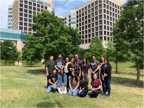 Lab team outside university buildings.