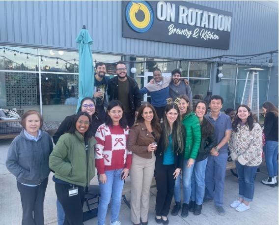 The lab team poses in front of a  building, On Rotation Brewery & Kitchen.