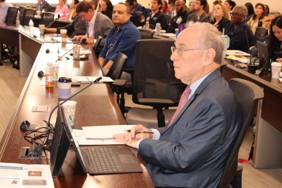 Dr. Philippe Zimmern at a table in the audience with his computer