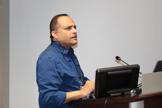 Dr. Amol Partwardhan standing at podium speaking 