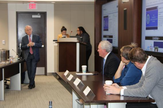 Dr. Zimmern talking to Drs. Clemens, Carmel, Partwardhan and Kolber in front of the room during a panel discussion