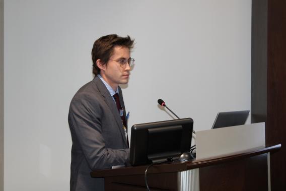 Urogynecology and Reconstructive Pelvic Surgey Fellow, Dr. Frank Jefferson during his presentation at a podium