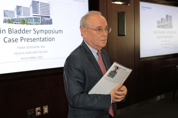 Dr. Zimmern in front of the room speaking to the audience