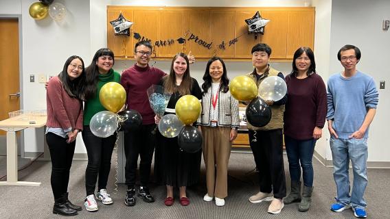 lab members with ballons in a conference room