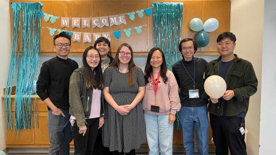lab members with welcome baby sign