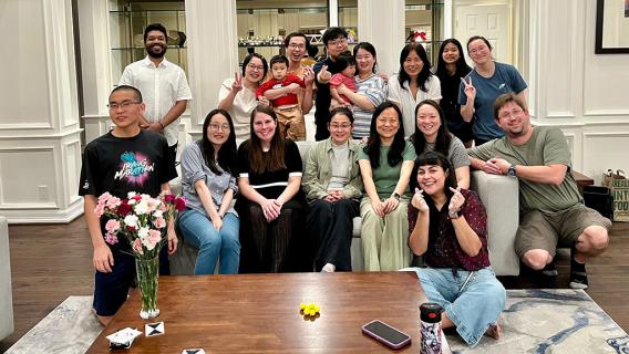 lab group gather on a couch in a home