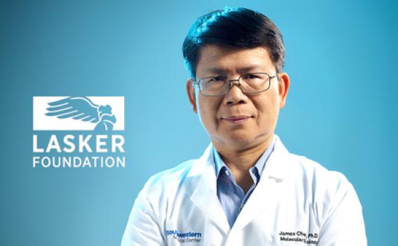 Man with dark hair, glasses wearing white lab coat next to Lasker Foundation logo.