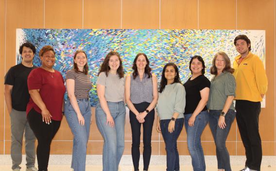 Lab Members standing in front of abstract painting