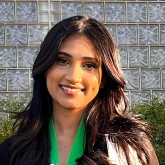 a woman with long dark hair and a green shirt