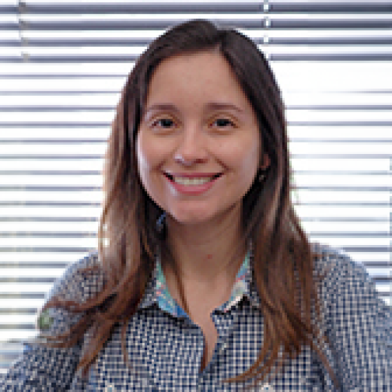 a woman with long brown hair wearing a checkered shirt