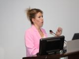 Dr. Maude Carmel standing at podium speaking