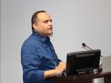 Dr. Amol Partwardhan standing at podium speaking 