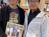 Dr. Sun with Tingxin holding lab group picture