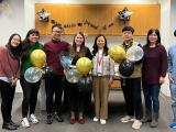 lab members with ballons in a conference room