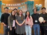 lab members with welcome baby sign