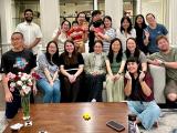 lab group gather on a couch in a home