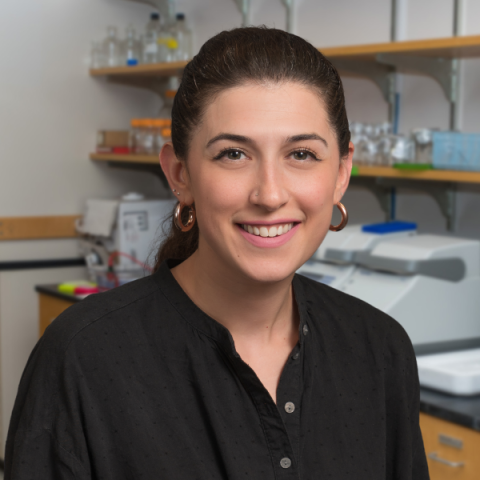 Zoe Pulitzer wearing a black shirt standing in a laboratory