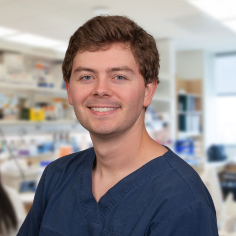 Placeholder a man wearing blue scrubs standing in a research laboratoryimage