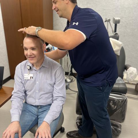 professor using TMS machine on person