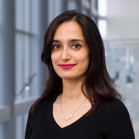 a woman with long dark hair wearing a black shirt