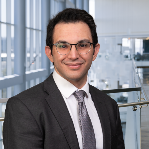 Dr. Amad Anouti wearing a dark gray suit in the lobby of Clements University Hospital