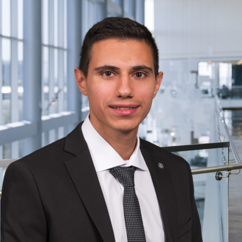 Dr. Elias Rady wearing a dark suit in the lobby of Clements University Hospital