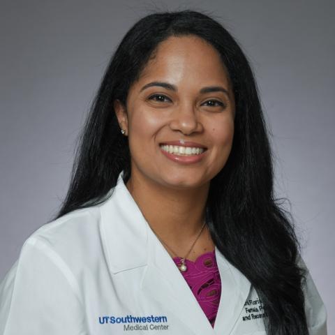 Woman with long dark hair wearing white lab coat; Dr. Maria Florian-Rodriguez